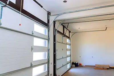 Inside view of a white garage door with a row of windows
