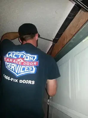 Action Garage Door technician working on a garage door